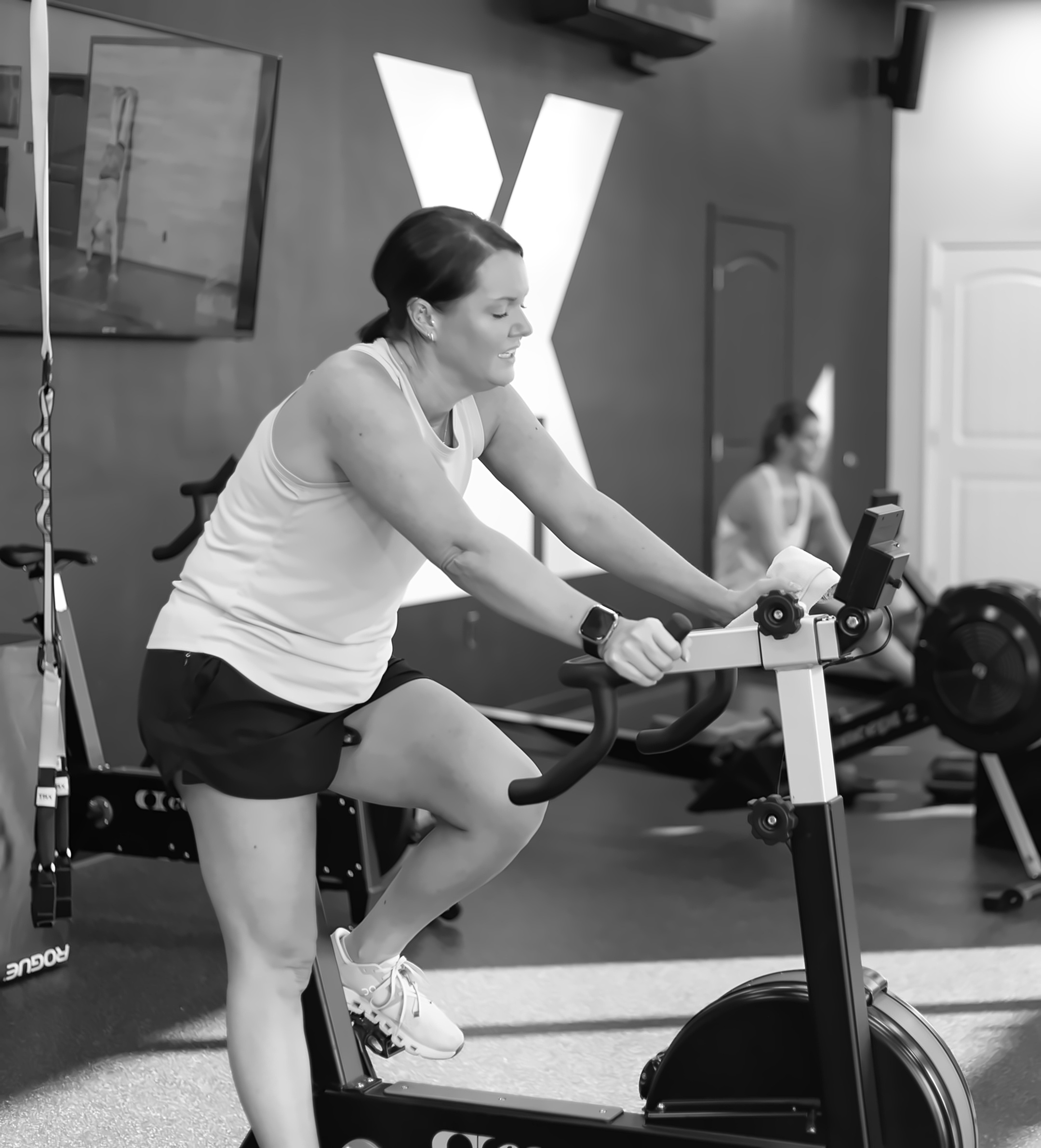 Coach guiding a member through a workout at X4 Statesboro